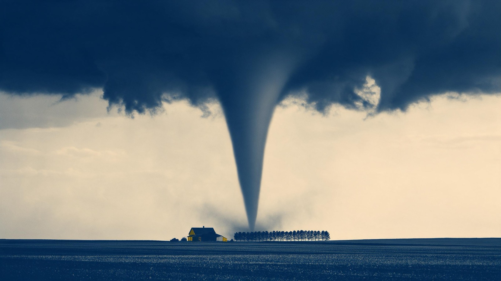 A tornado funnel touching down over flat farmland at dusk, a lone farmhouse and a line of windbreak trees small beneath it